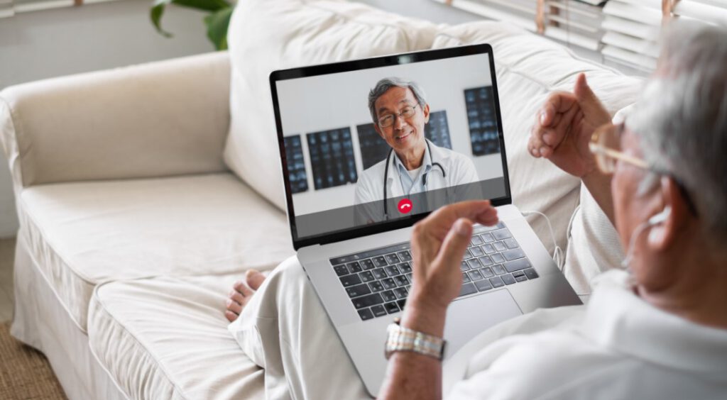 blog-telehealth.jpg - Anthem Lakes Senior Living Senior man have a telehealth visit with a doctor on a laptop
