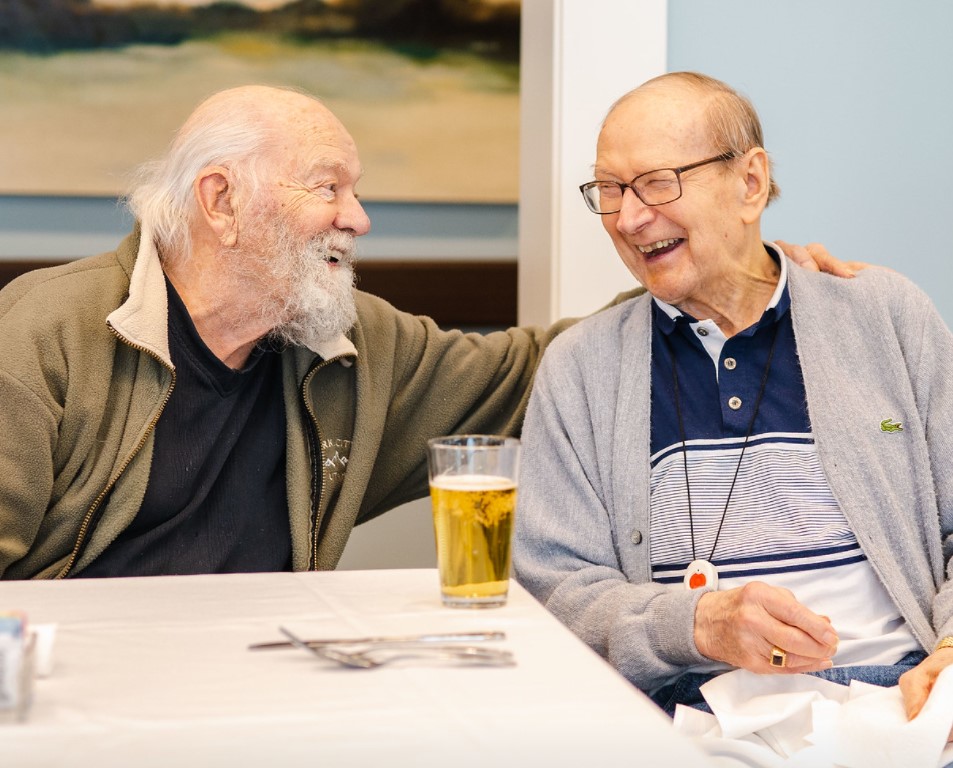 blog-keeping-busy-in-a-senior-community.jpg - Anthem Lakes Senior Living Senior man seated and laughing over beers